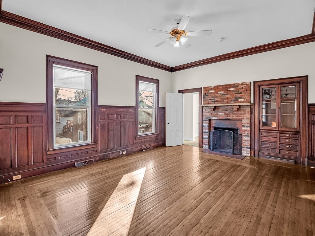 775 Bridge Street Lowell, MA 01850 - Photo 6 of 42 a view of an empty room with wooden floor and a window