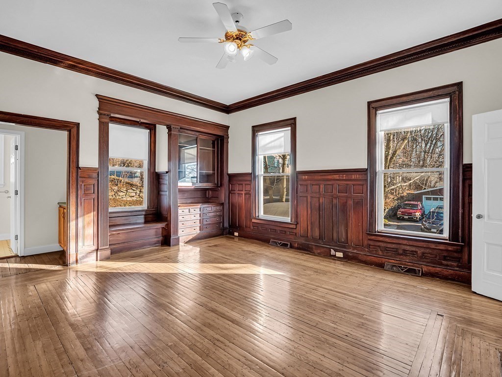775 Bridge Street Lowell, MA 01850 - Photo 7 of 42 an empty room with wooden floor and windows