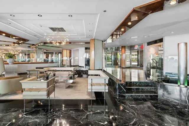a living room with lots of furniture and view of kitchen