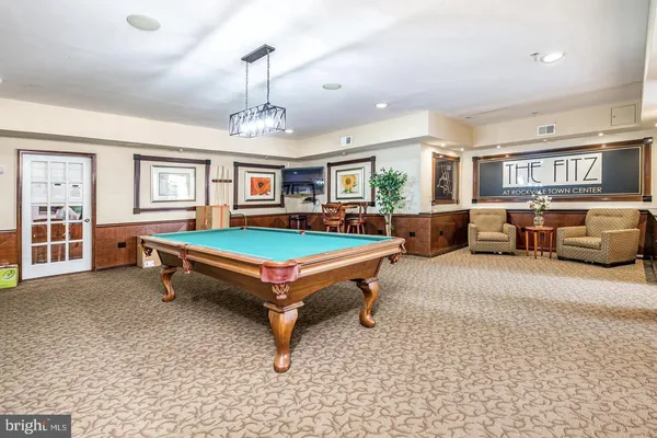 a living room with furniture pool table and a window