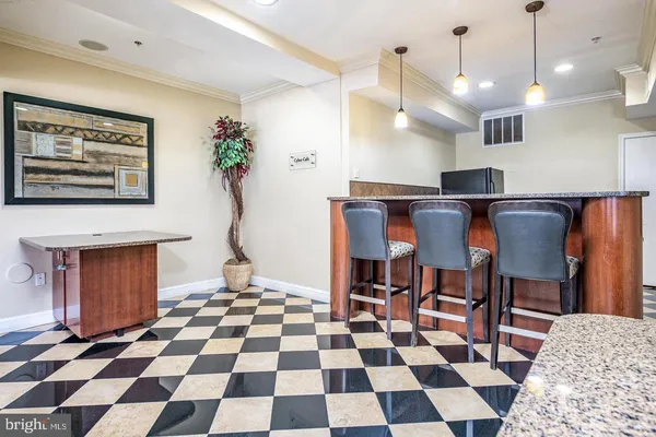 a living room with a black white checkered floor with a dining table and chairs