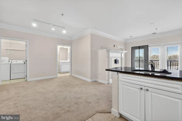 a view of kitchen with granite countertop cabinets and sink
