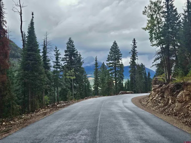 a view of a road with a trees in the background