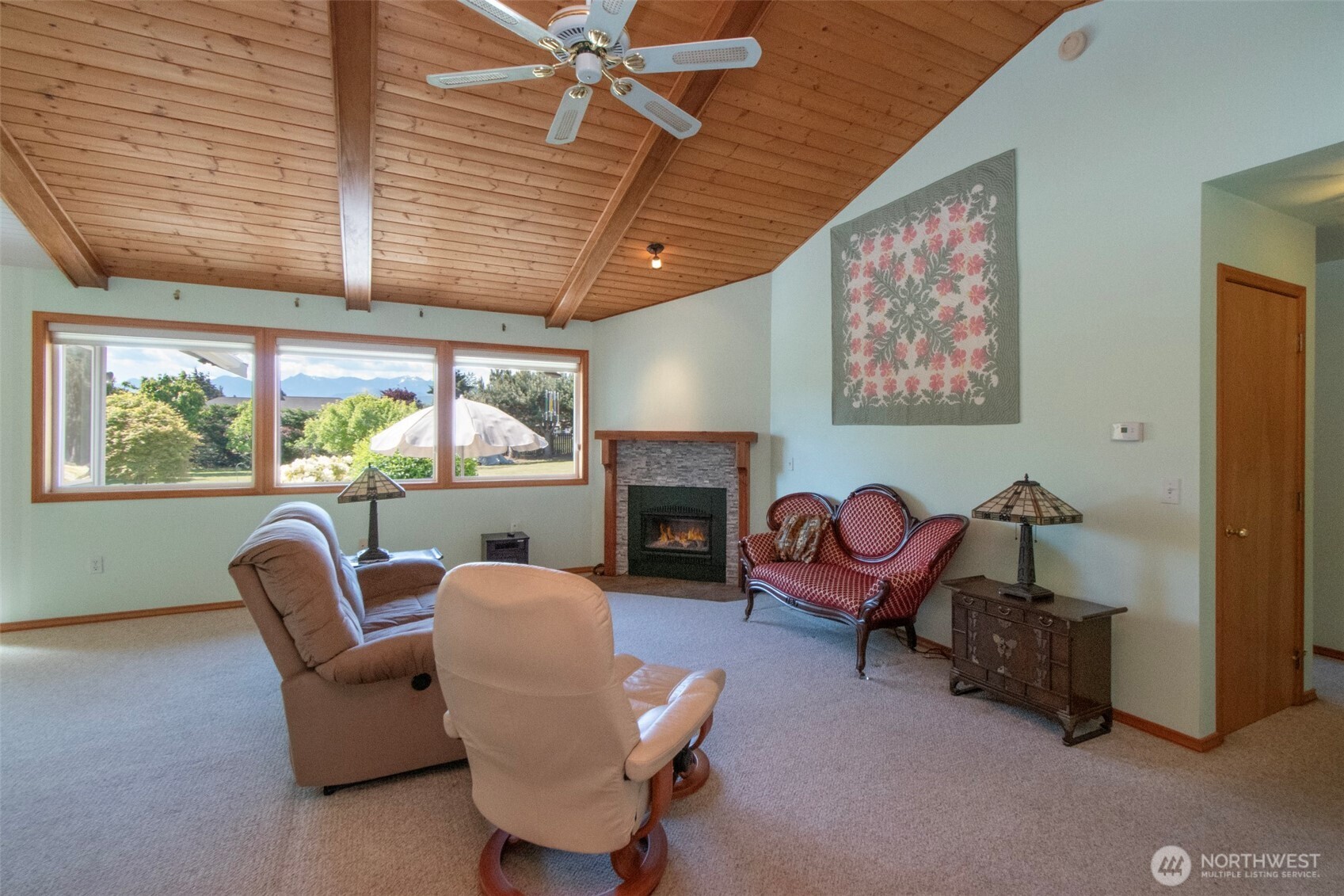 101 Timothy Lane Sequim, WA 98382 - Photo 4 of 39 a living room with furniture a fireplace and a large window