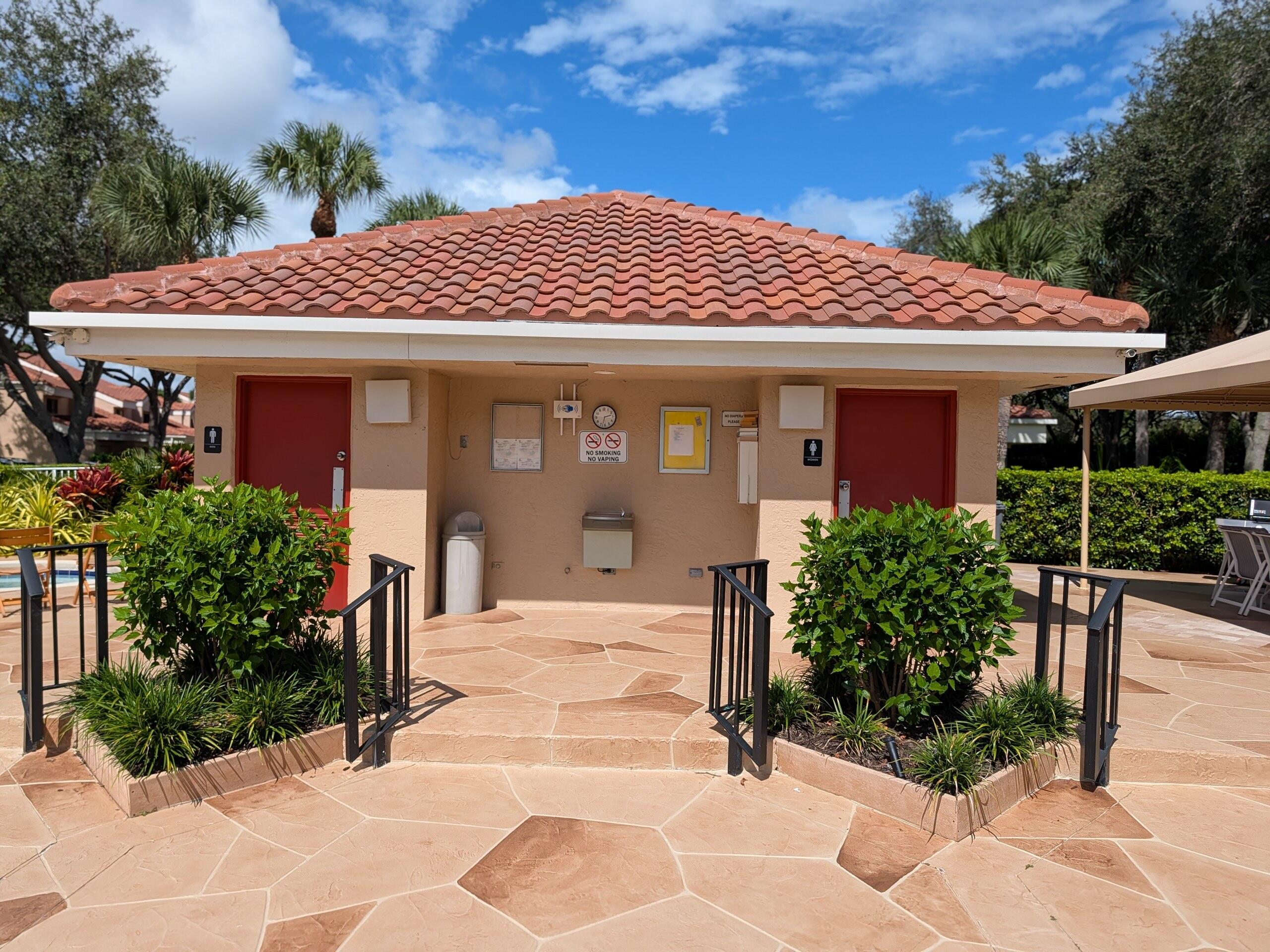 17372 Boca Club Boulevard, Unit 405 Boca Raton, FL 33487 - Photo 65 of 74 a front view of a house with a garden