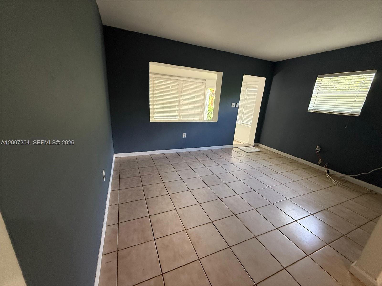 2483 Southwest 11th Street, Unit 2483 Miami, FL 33135 - Photo 2 of 12 a view of an empty room and window