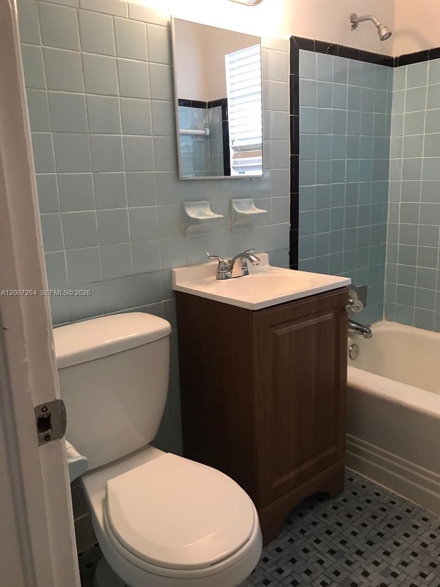 2483 Southwest 11th Street, Unit 2483 Miami, FL 33135 - Photo 5 of 12 a bathroom with a sink a toilet and bathtub