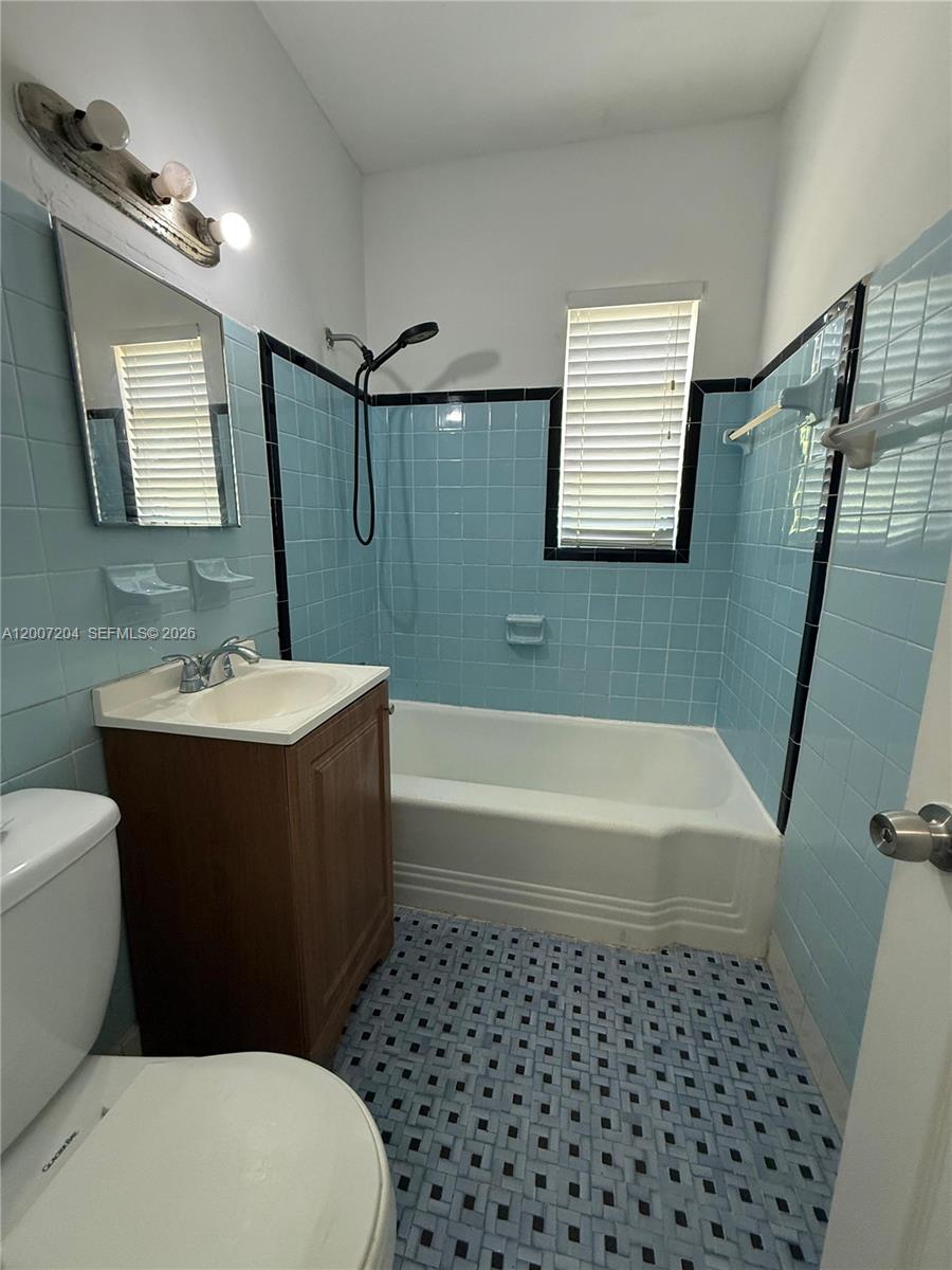 2483 Southwest 11th Street, Unit 2483 Miami, FL 33135 - Photo 10 of 12 a bathroom with a sink a toilet and bathtub