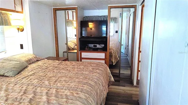 a bedroom with a bed and a mirror