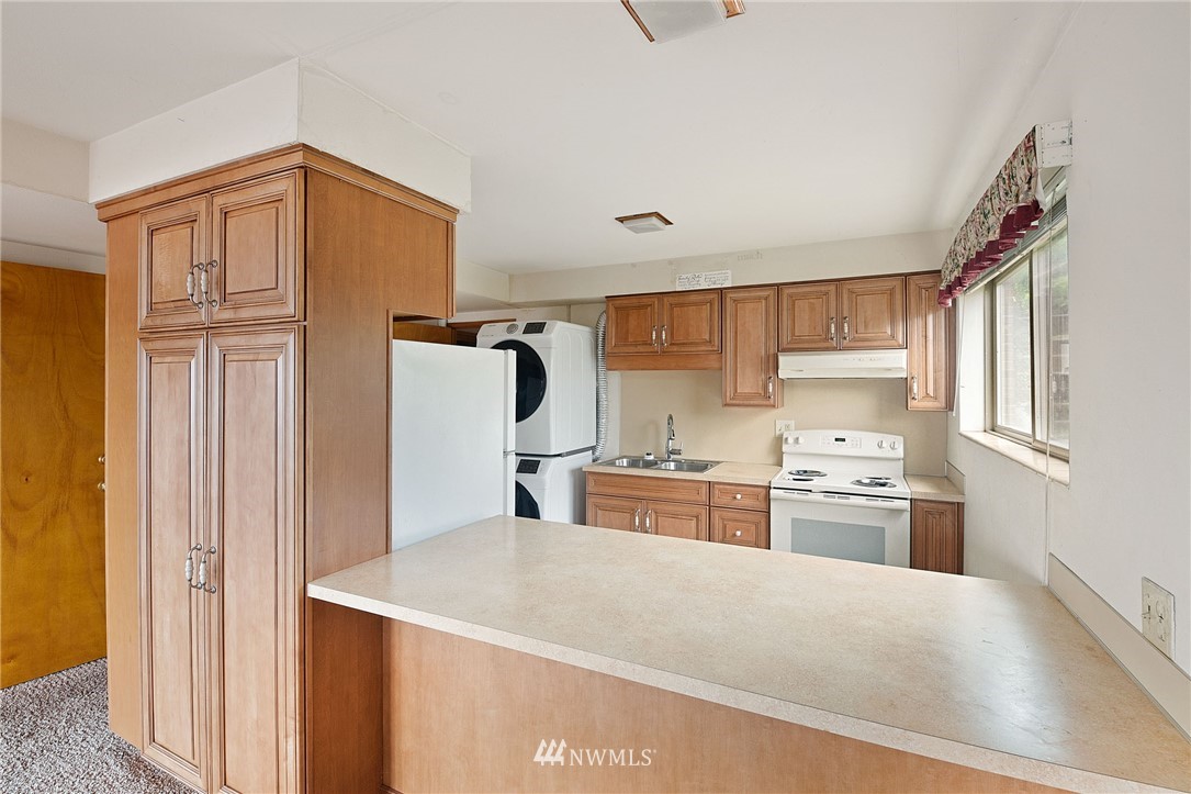 7724 South Sunnycrest Road Seattle, WA 98178 - Photo 11 of 21 a kitchen with stainless steel appliances granite countertop a refrigerator sink stove and microwave