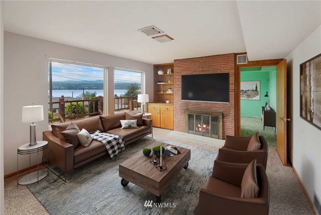 7724 South Sunnycrest Road Seattle, WA 98178 - Photo 12 of 21 a living room with furniture a flat screen tv and a fireplace