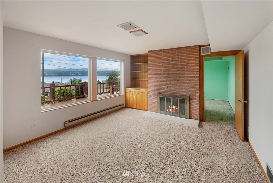 7724 South Sunnycrest Road Seattle, WA 98178 - Photo 13 of 21 a view of an empty room with a fireplace and a window