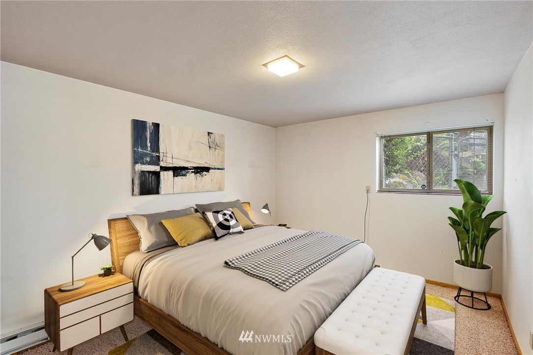 7724 South Sunnycrest Road Seattle, WA 98178 - Photo 16 of 21 a bedroom with a bed and wooden floor