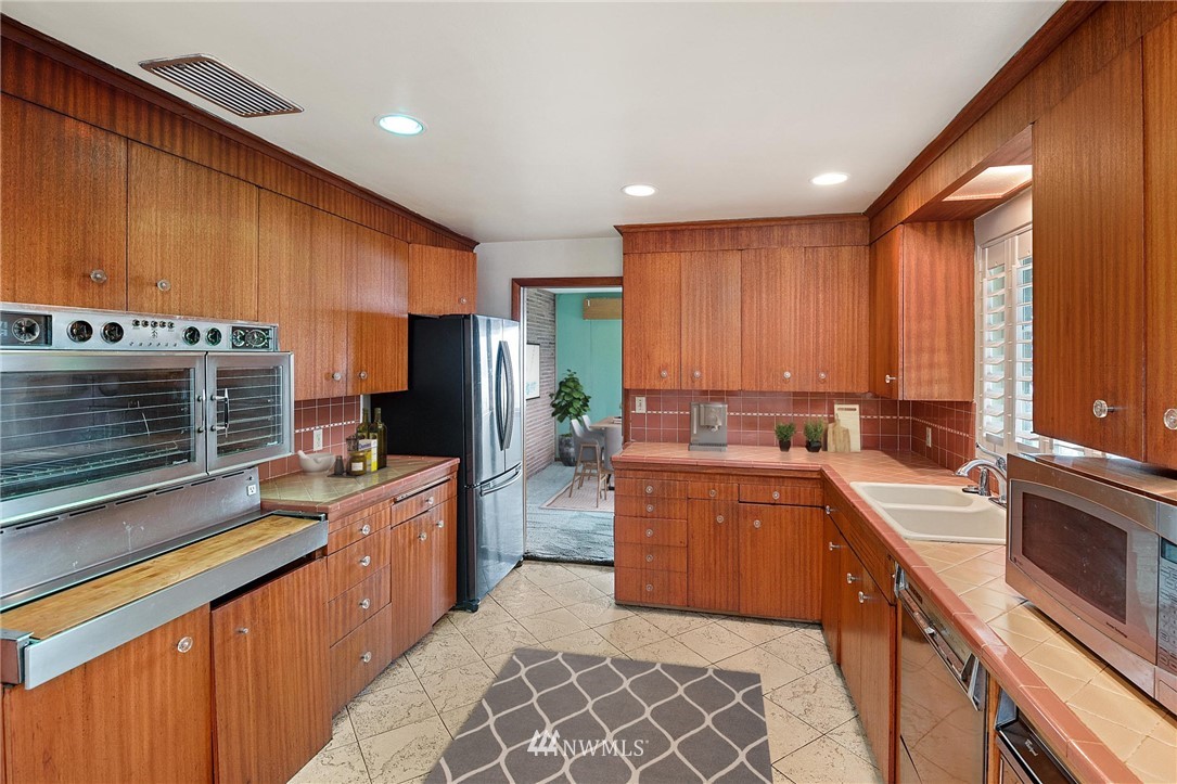 7724 South Sunnycrest Road Seattle, WA 98178 - Photo 9 of 21 a kitchen with a sink stove and cabinets