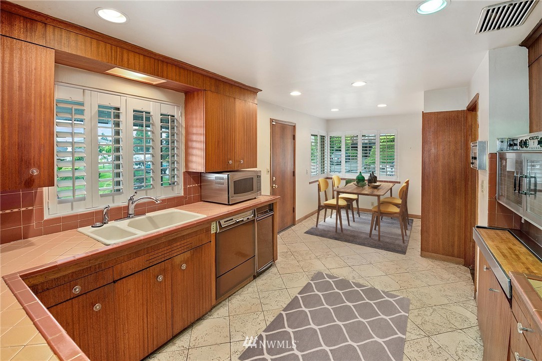 7724 South Sunnycrest Road Seattle, WA 98178 - Photo 10 of 21 a large kitchen with kitchen island granite countertop a large counter top space and stainless steel appliances