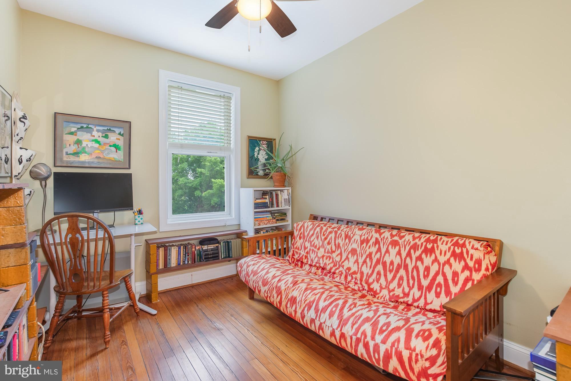 116 V Street Northeast Washington, DC 20002 - Photo 15 of 26 a bedroom with a bed and a chair