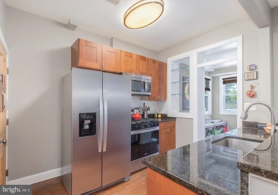 116 V Street Northeast Washington, DC 20002 - Photo 5 of 26 a kitchen with stainless steel appliances granite countertop a sink and a refrigerator
