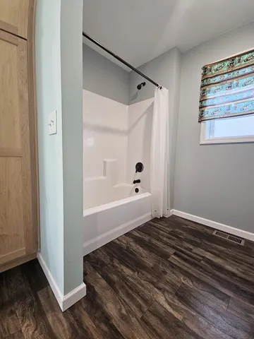 a bedroom with a bed and a dresser