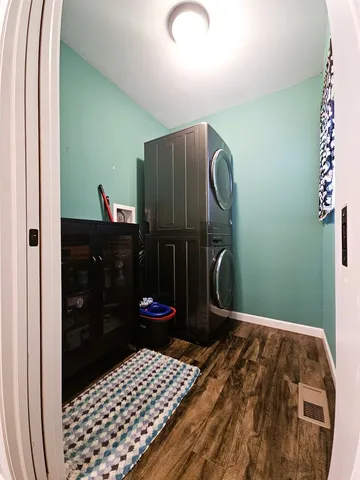 an empty room with wooden floor and ceiling fan