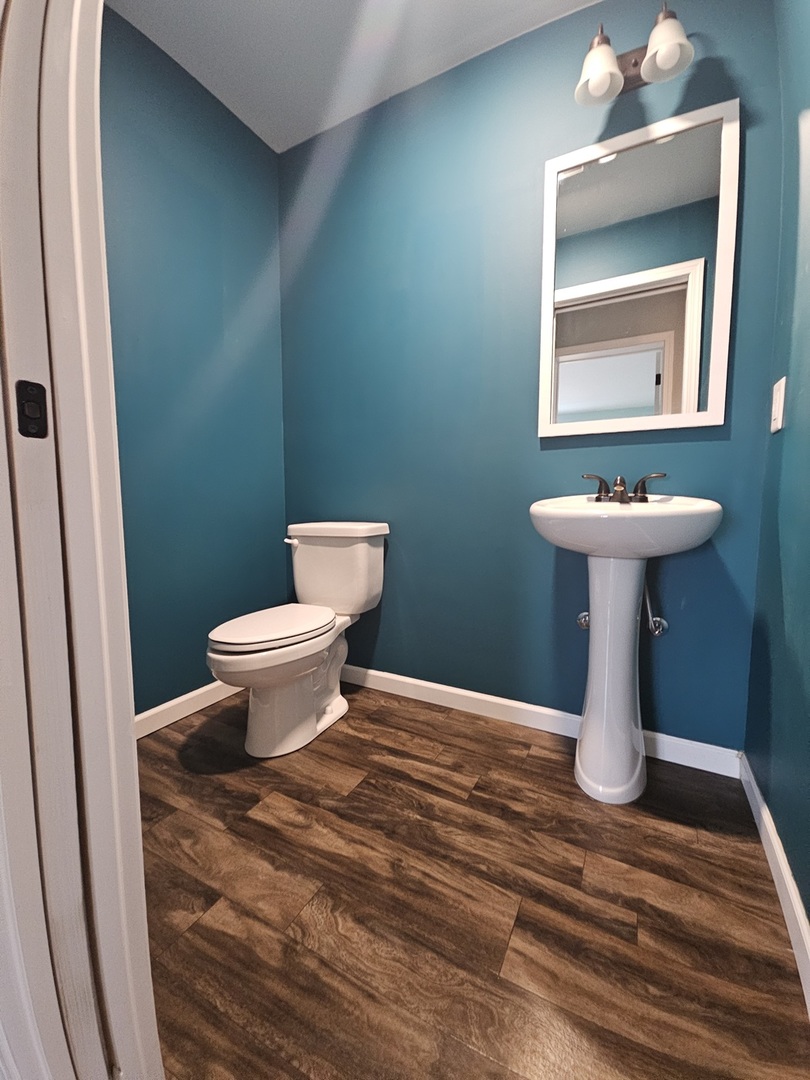 809 McCoy Road Amboy, IL 61310 - Photo 21 of 58 a bathroom with a toilet sink and mirror