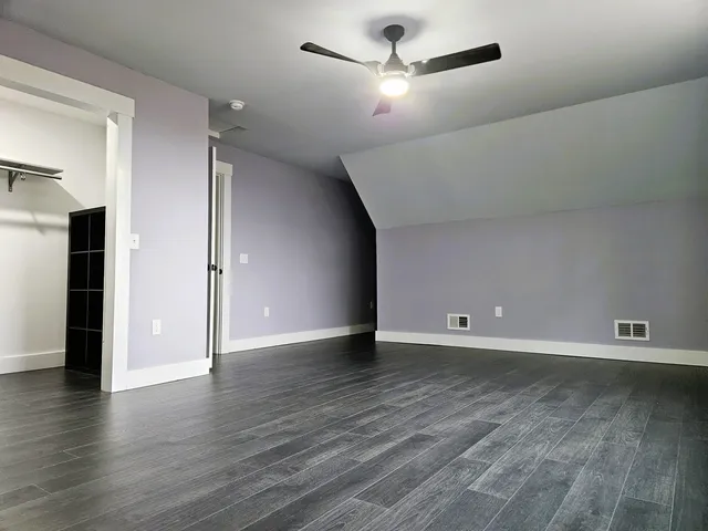 a view of walk in closet with empty racks