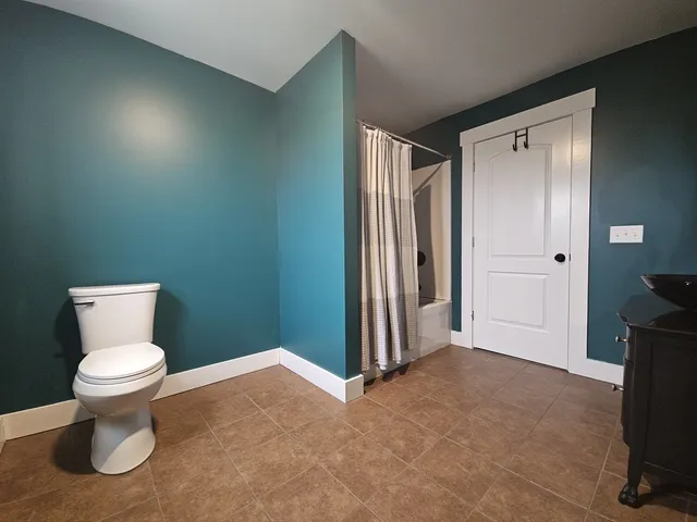 a view of a room with rack and wooden floor
