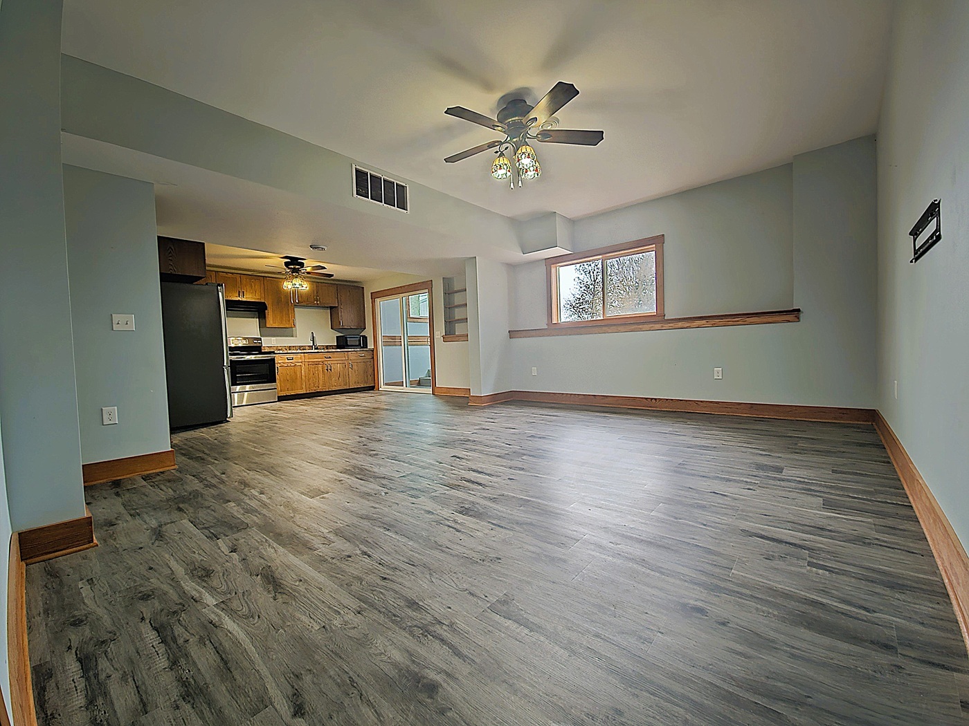 809 McCoy Road Amboy, IL 61310 - Photo 34 of 58 a view of a livingroom with wooden floor and a ceiling fan