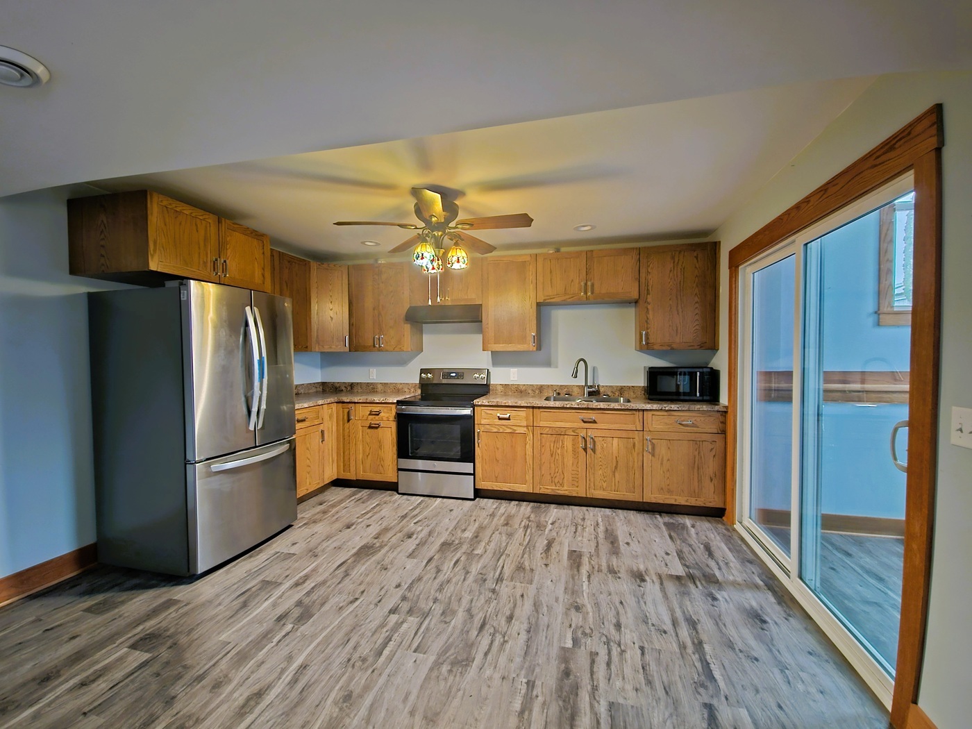 809 McCoy Road Amboy, IL 61310 - Photo 35 of 58 a kitchen with stainless steel appliances wooden floor sink and refrigerator