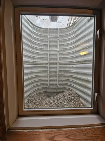 a view of a kitchen with a sink and a refrigerator