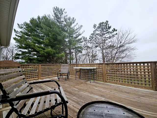 a view of a lake with a bench and trees