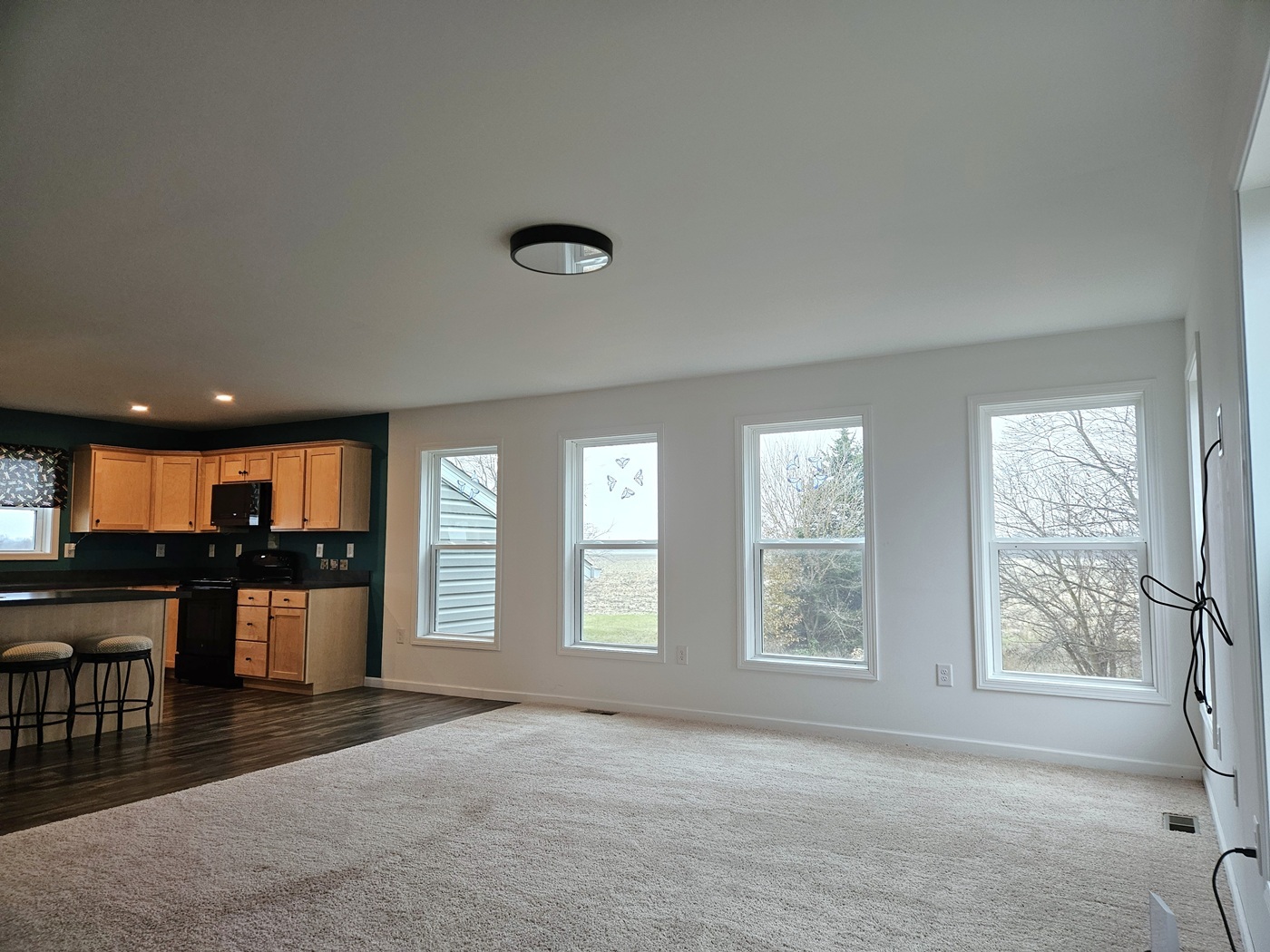 809 McCoy Road Amboy, IL 61310 - Photo 9 of 58 an empty room with chandelier fan and wooden floor