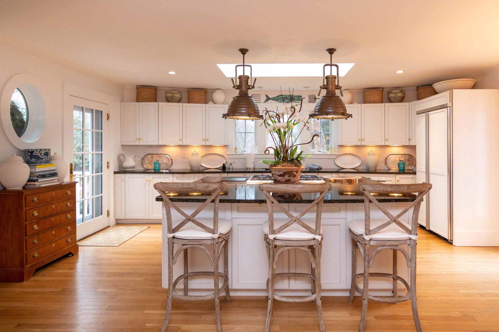 22 Edgartown Bay Road Edgartown, MA 02539 - Photo 12 of 55 a kitchen with a table chairs stove and wooden floor