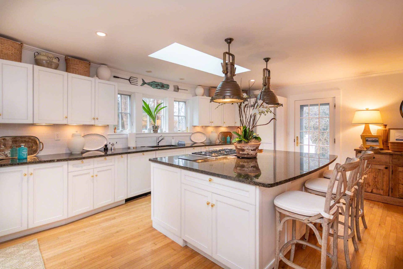 22 Edgartown Bay Road Edgartown, MA 02539 - Photo 14 of 55 a kitchen with a table chairs sink and cabinets