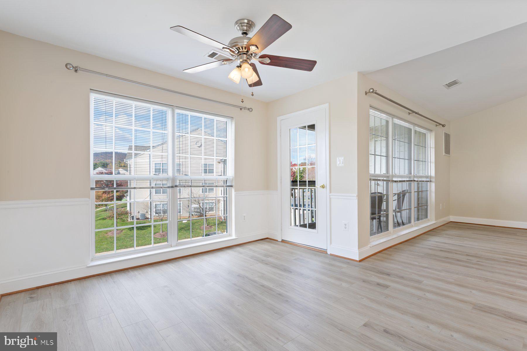 2500 Hemingway Drive, Unit 33D Frederick, MD 21702 - Photo 11 of 29 a view of an empty room with wooden floor and a window