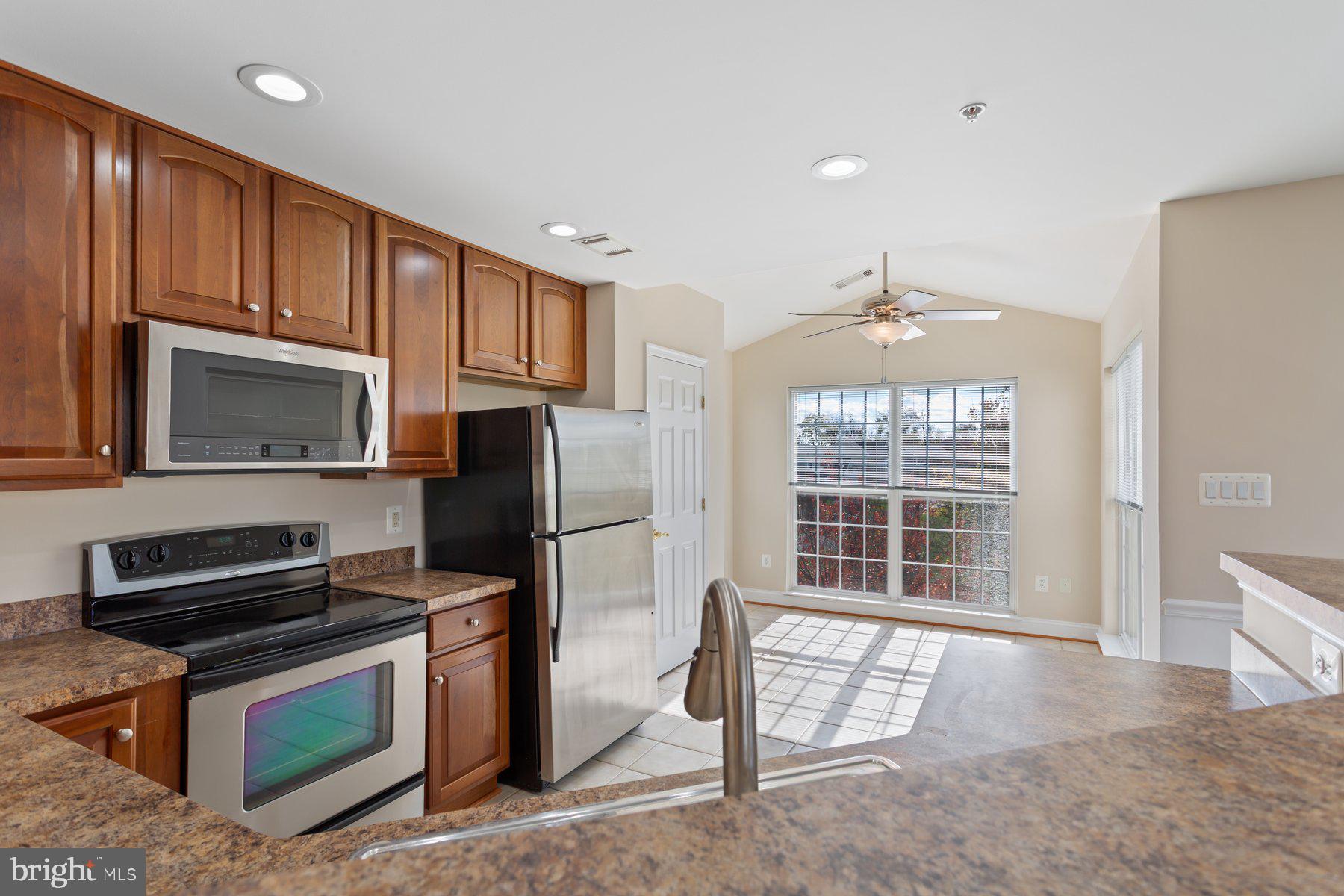 2500 Hemingway Drive, Unit 33D Frederick, MD 21702 - Photo 14 of 29 a kitchen with wooden cabinets and a stove top oven