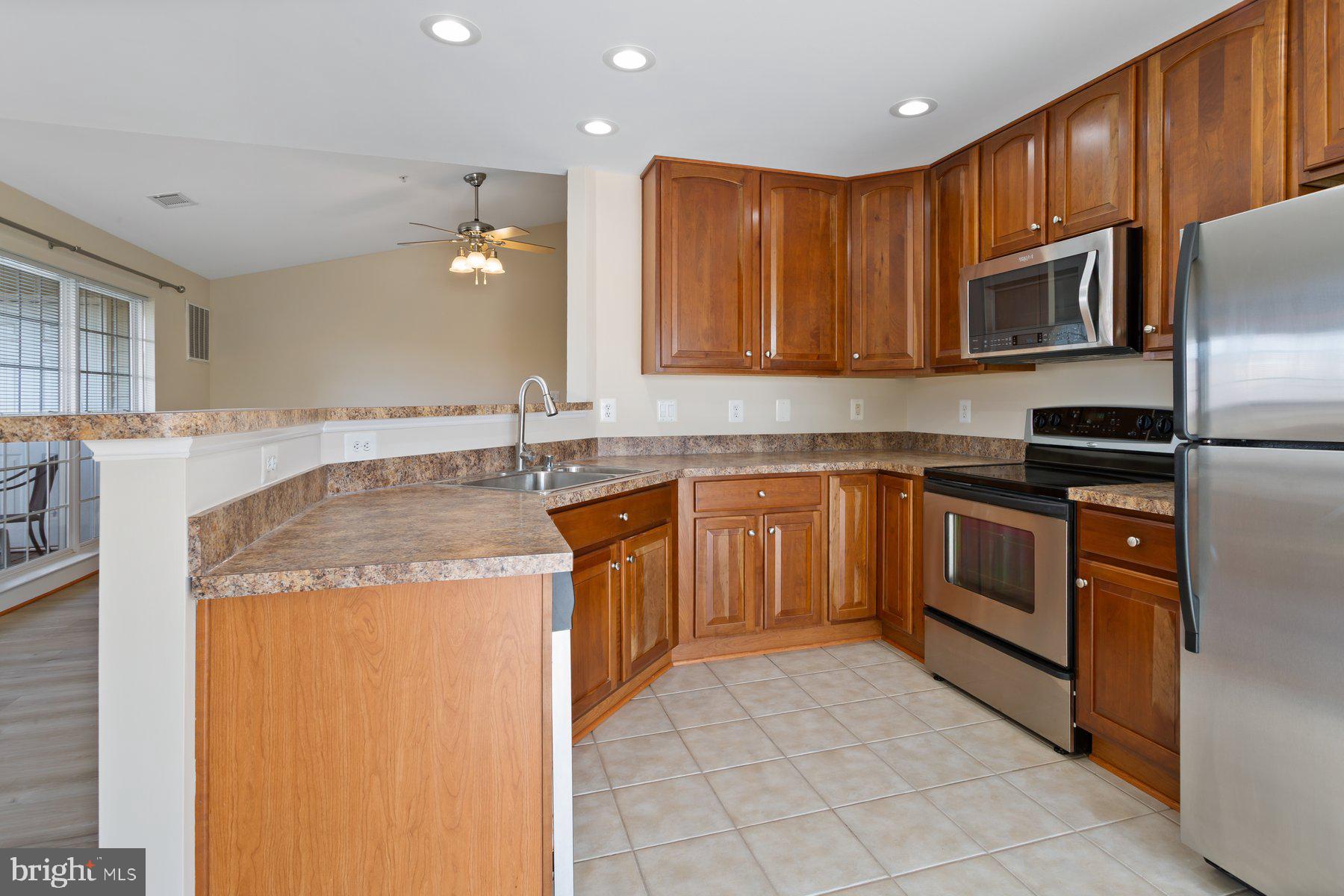 2500 Hemingway Drive, Unit 33D Frederick, MD 21702 - Photo 15 of 29 a kitchen with stainless steel appliances granite countertop a stove a sink and a refrigerator