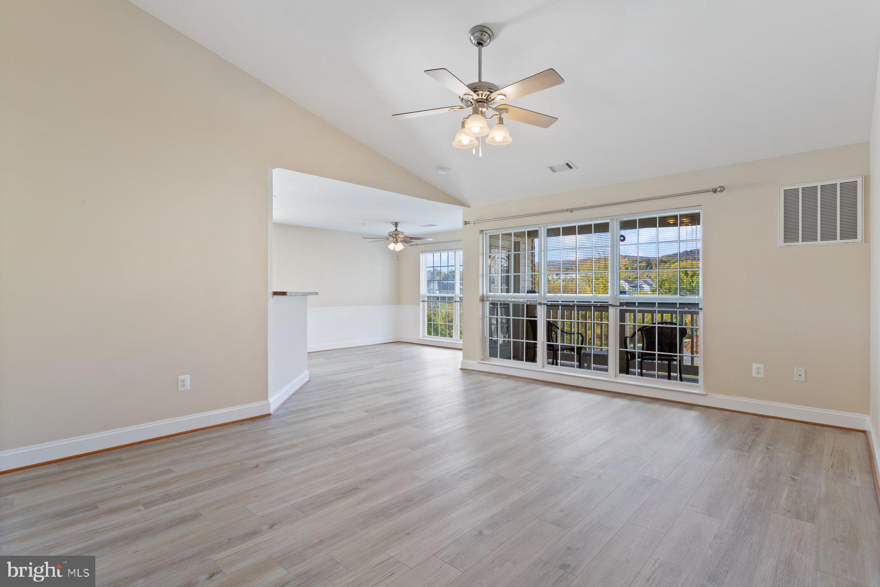 2500 Hemingway Drive, Unit 33D Frederick, MD 21702 - Photo 5 of 29 a view of an empty room with wooden floor and a window
