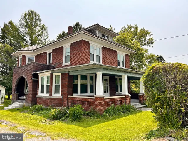 a view of a brick house with windows and yard