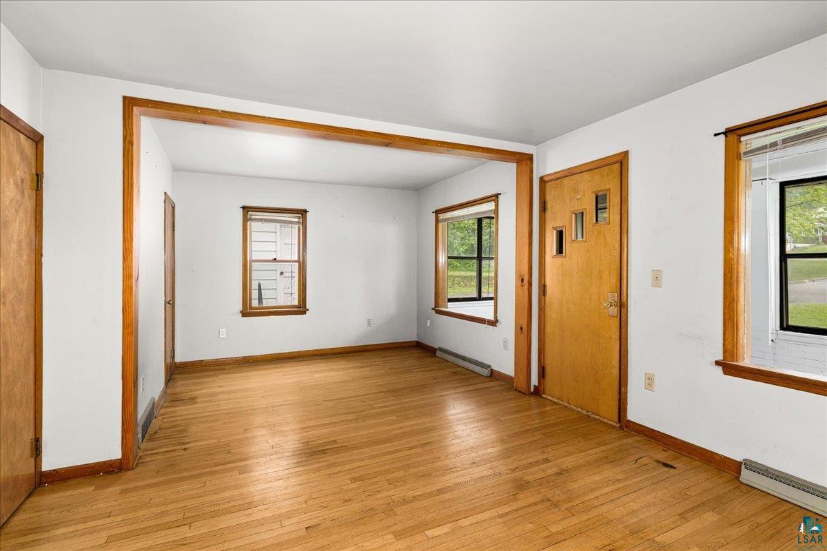 424 East Upham Road Duluth, MN 55811 - Photo 21 of 38 Hardwood flooring throughout a bright room featuring white walls and natural wood trim