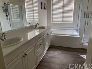 46326 Cask Lane Temecula, CA 92592 - Photo 13 of 22 a bathroom with a double vanity sink a mirror and a bathtub