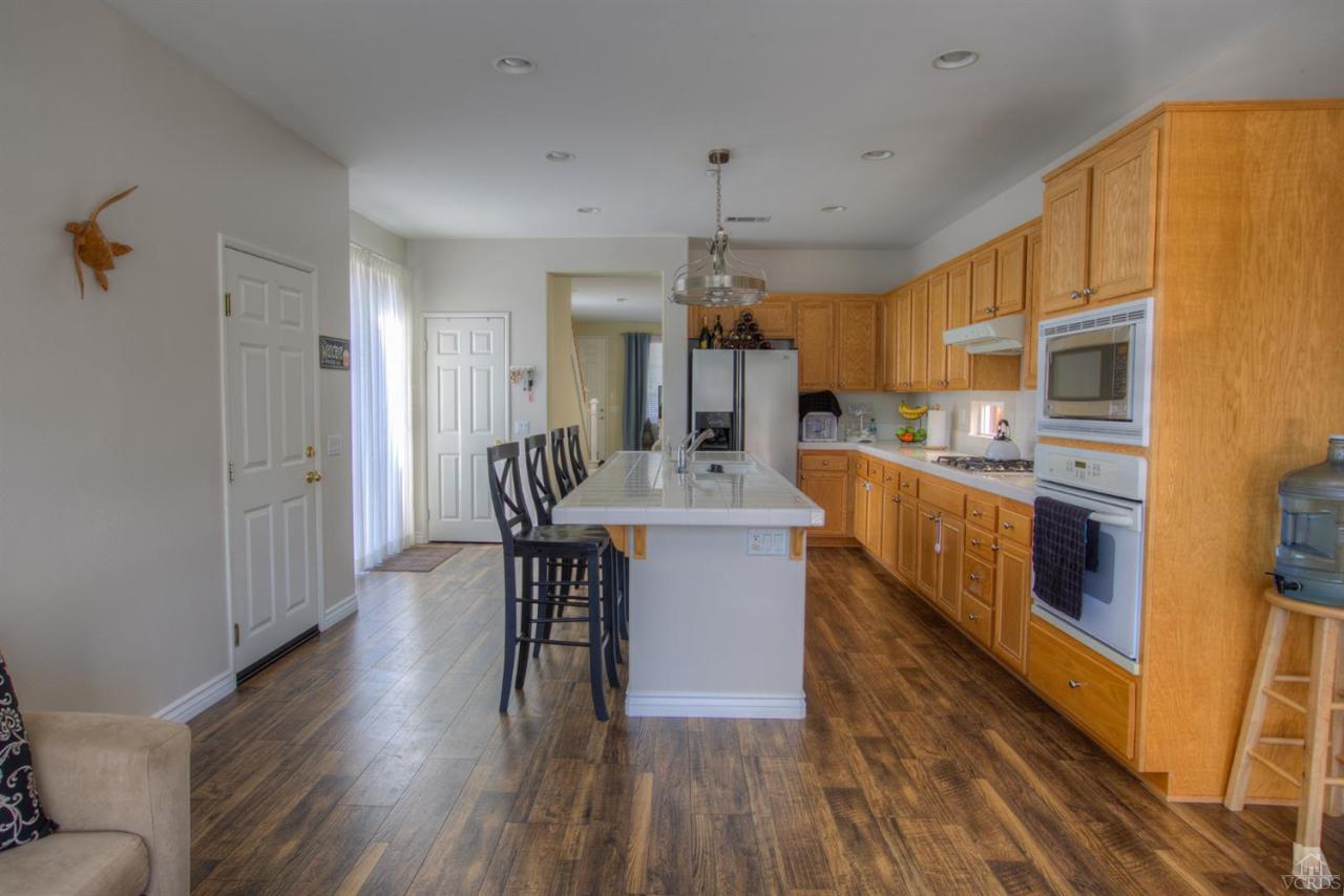 546 Morado Place Oxnard, CA 93030 - Photo 11 of 41 a view of a dining room kitchen with furniture and wooden floor