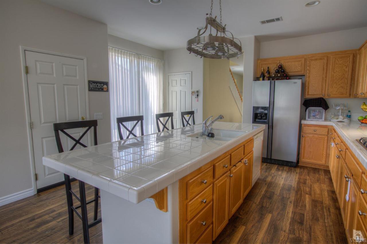 546 Morado Place Oxnard, CA 93030 - Photo 12 of 41 a kitchen with sink cabinets and wooden floor