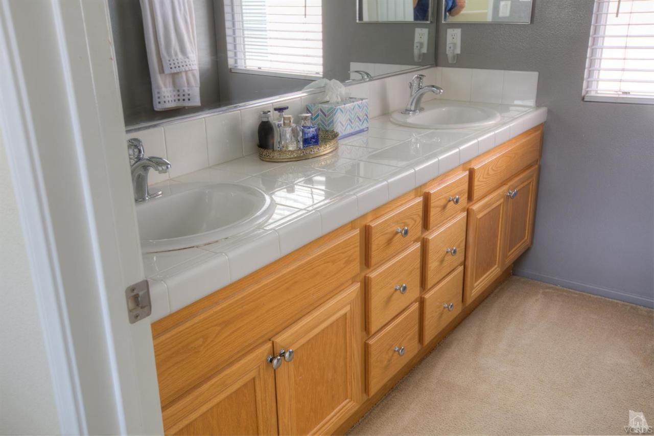 546 Morado Place Oxnard, CA 93030 - Photo 20 of 41 a bathroom with sink and mirror