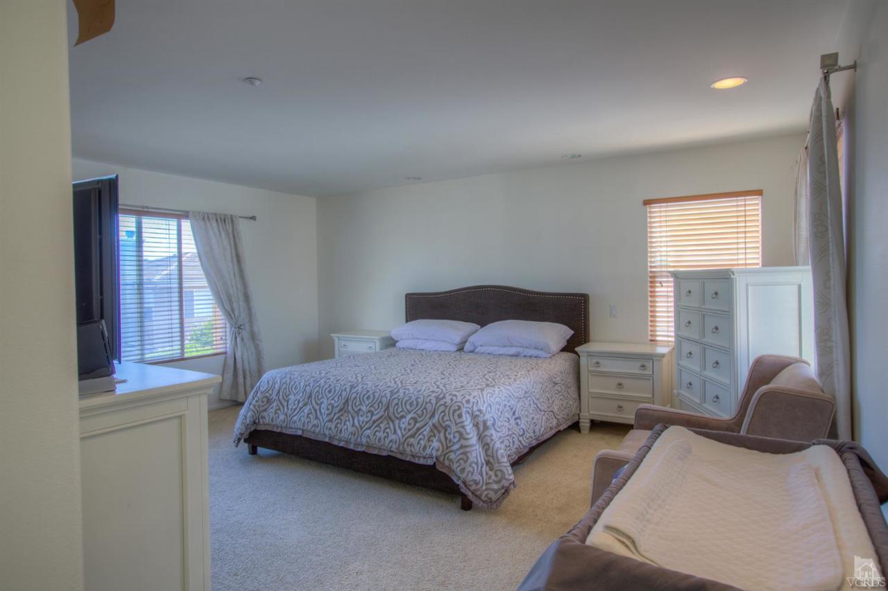 546 Morado Place Oxnard, CA 93030 - Photo 23 of 41 a bedroom with a bed and window