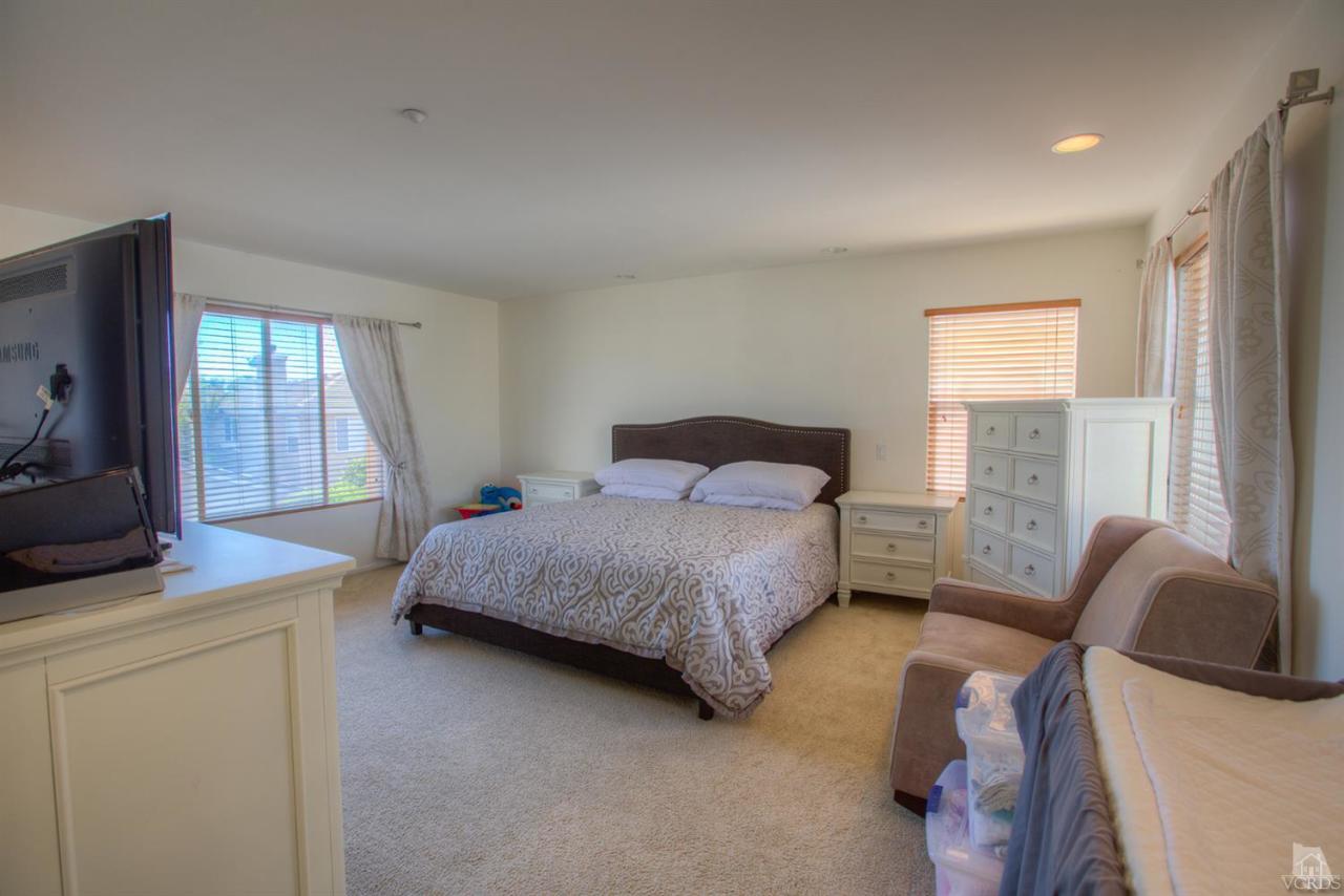 546 Morado Place Oxnard, CA 93030 - Photo 25 of 41 a bedroom with a bed and large window