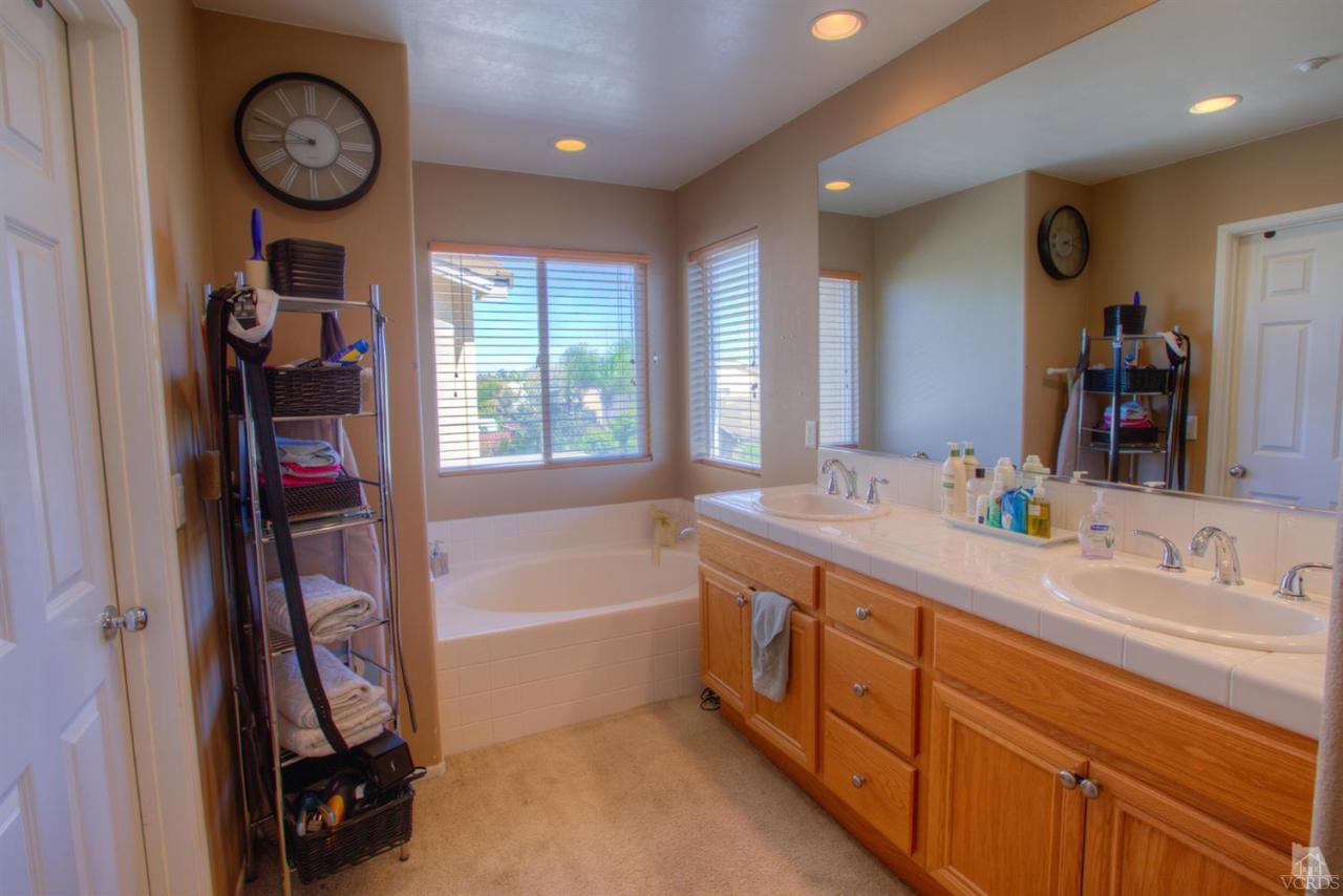 546 Morado Place Oxnard, CA 93030 - Photo 26 of 41 a bathroom with a double vanity sink and a large mirror