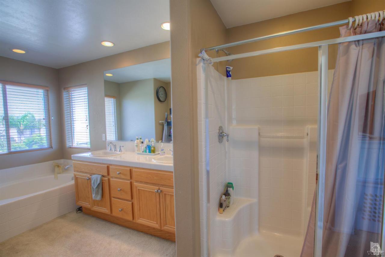 546 Morado Place Oxnard, CA 93030 - Photo 28 of 41 a bathroom with a tub sink shower and mirror
