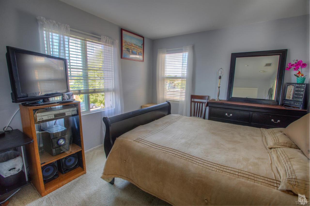 546 Morado Place Oxnard, CA 93030 - Photo 34 of 41 a bedroom with a bed and a flat screen tv