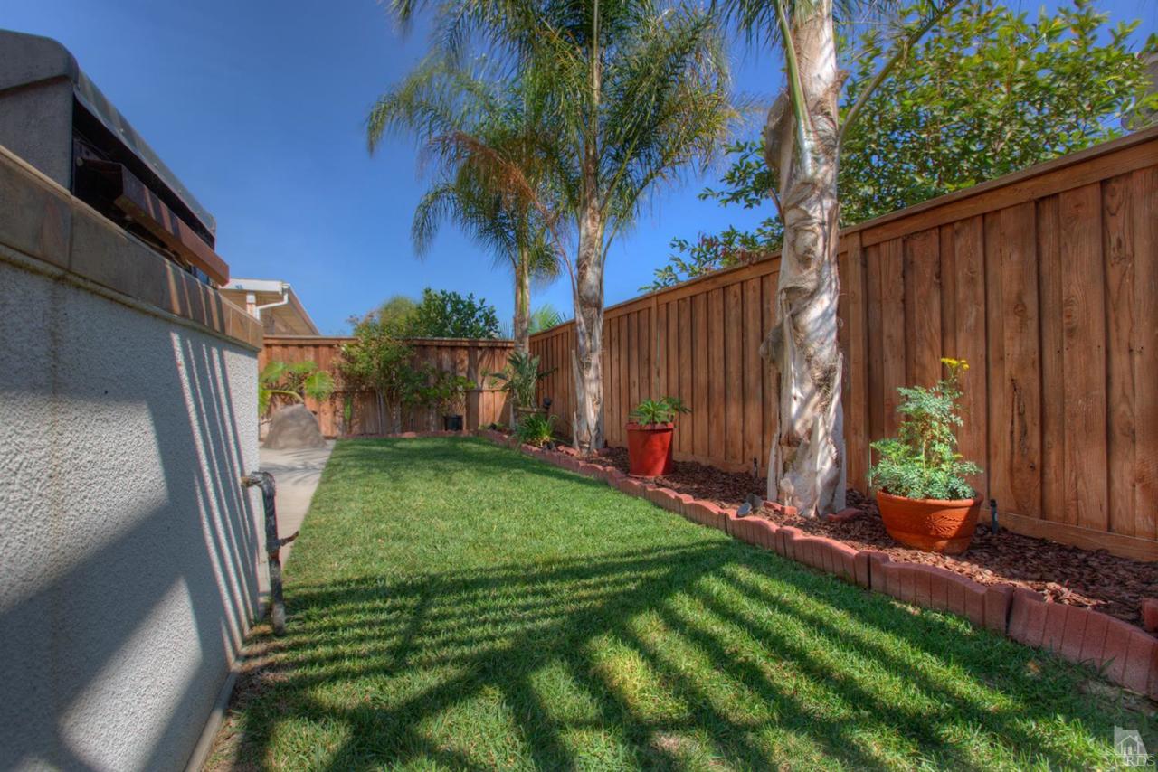 546 Morado Place Oxnard, CA 93030 - Photo 40 of 41 a view of backyard with potted plants and wooden fence