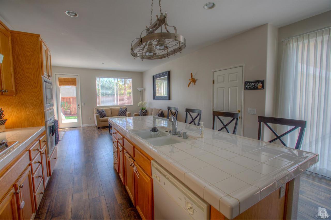 546 Morado Place Oxnard, CA 93030 - Photo 7 of 41 a view of a dining room with furniture and wooden floor